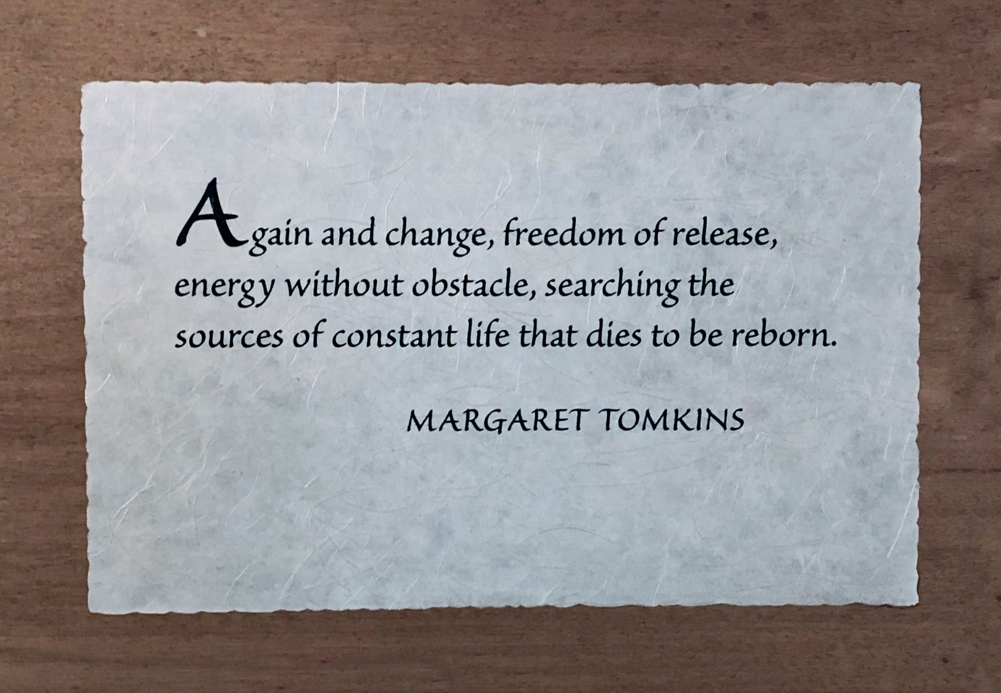 Photo of wooden plaque with Margaret Tomkins quote: “Again and change, freedom of release, energy without obstacle, searching the sources of constant life that dies to be reborn.” 