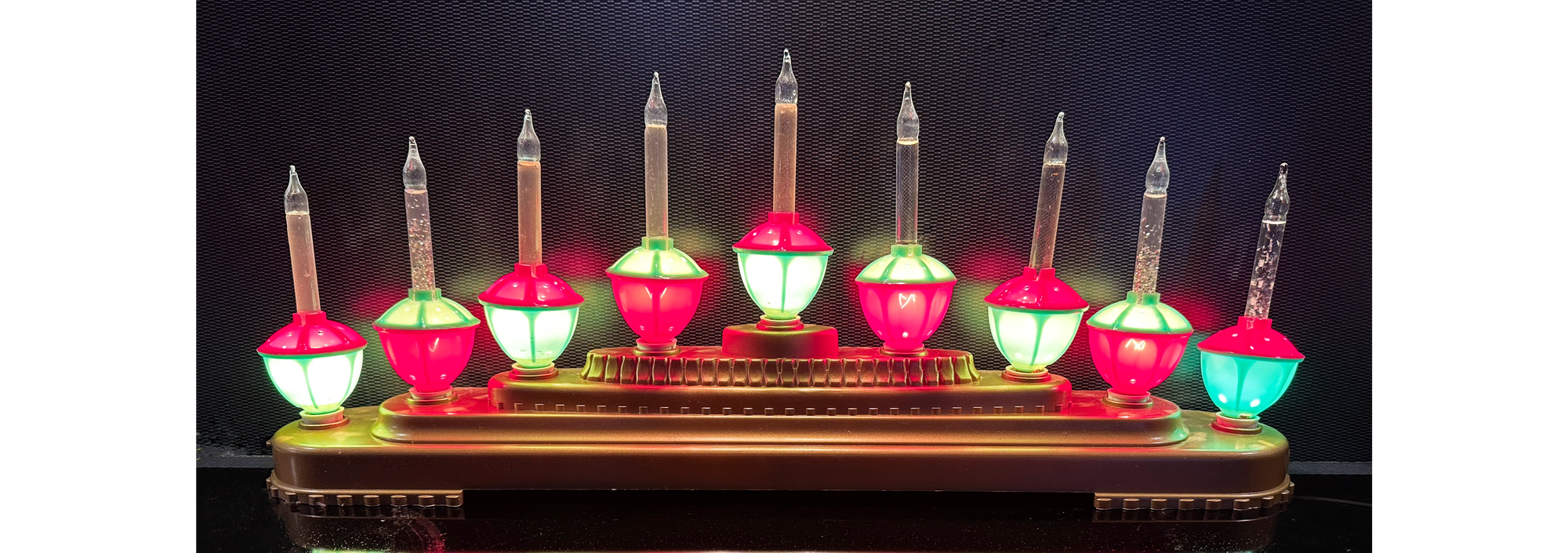 Five-tiered fake gold ziggurat with 9 red and green bubble lights on top.