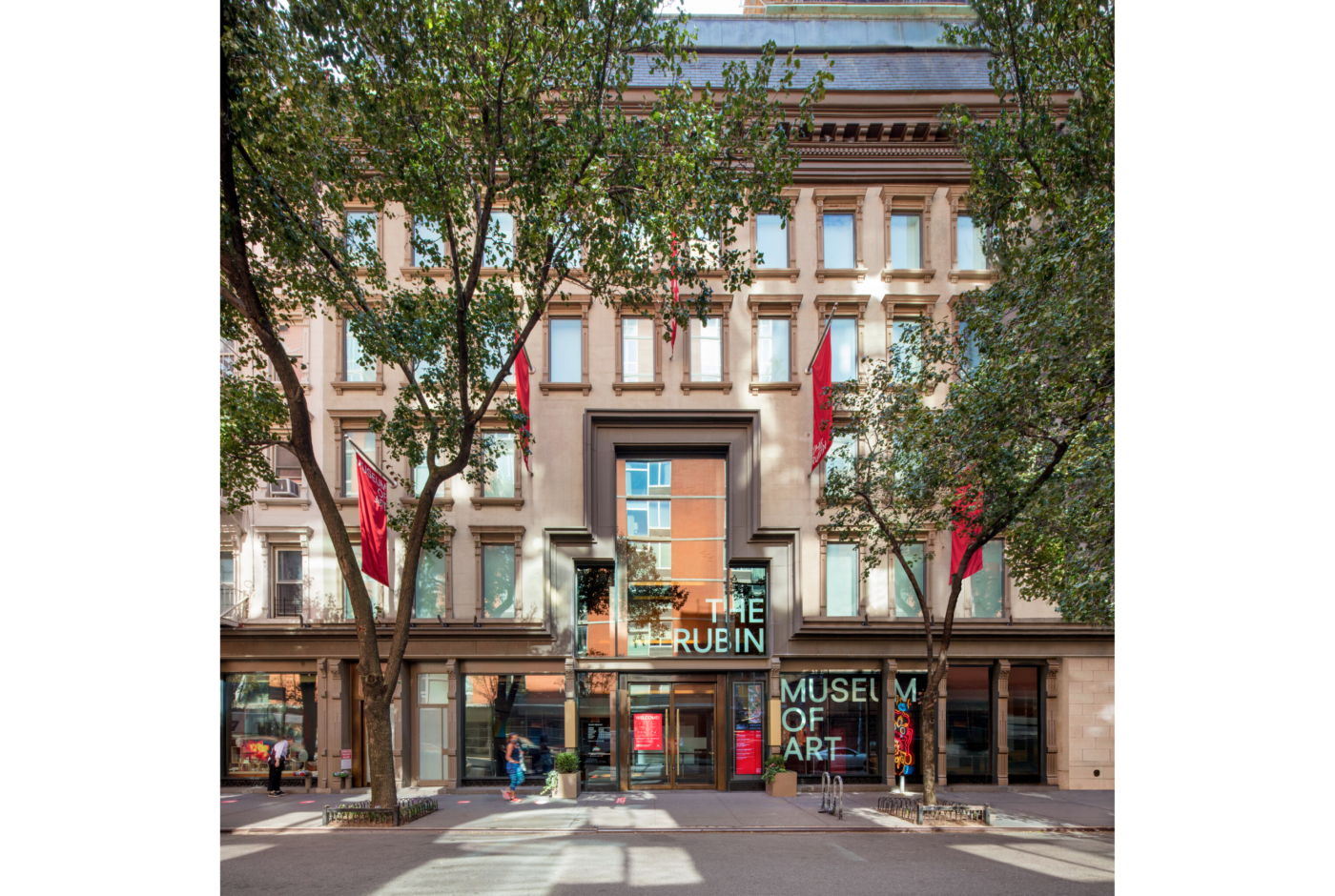 Photo of multi-story museum building with 2 trees in front