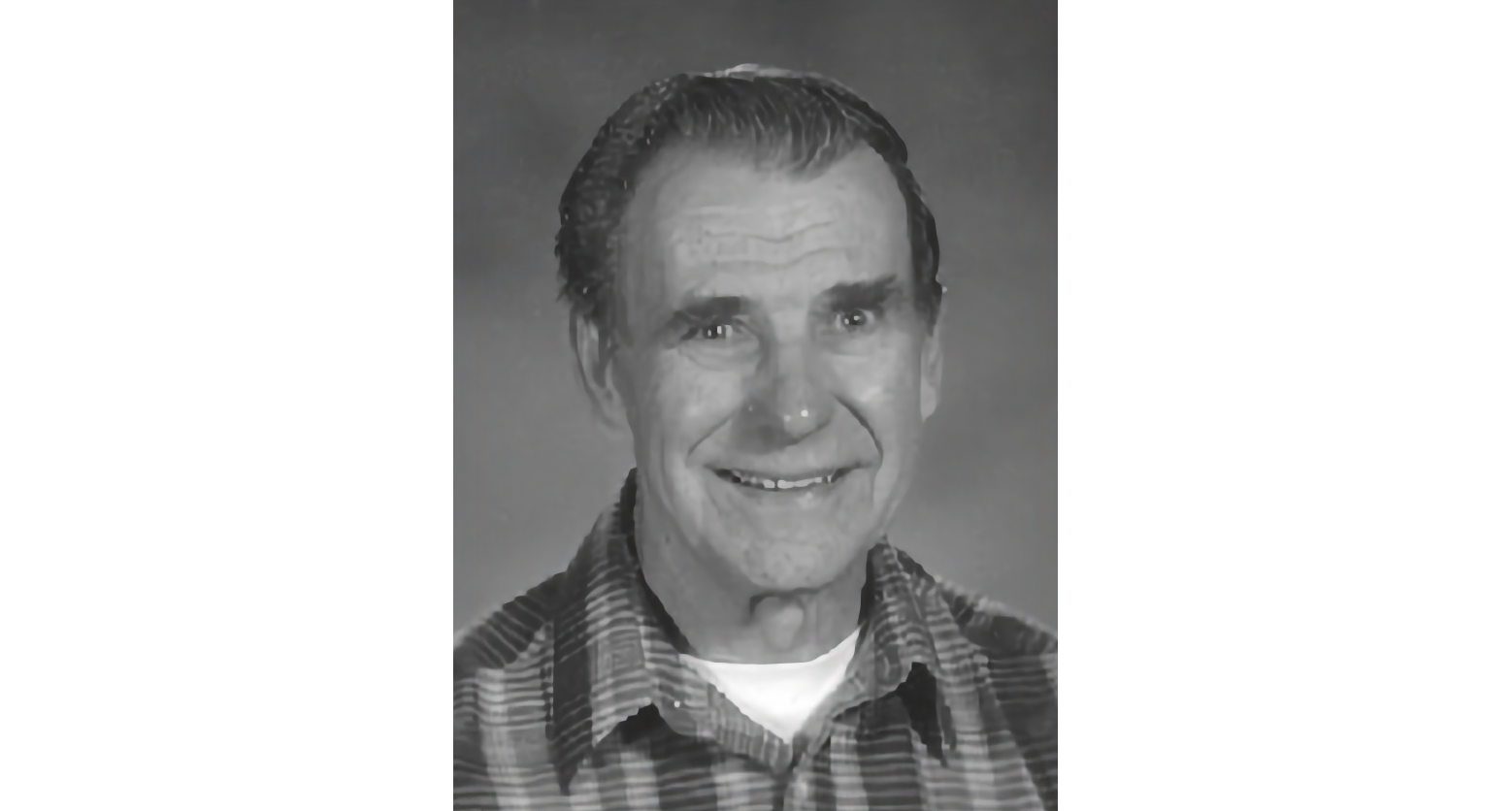 Black and white photo portrait of a smiling man