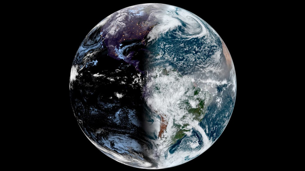 Photo of the earth from space, with left half in darkness and right half in sunlight.